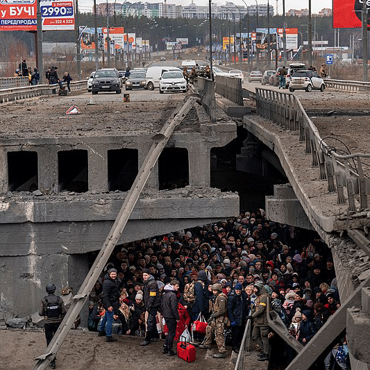 Ukrainian civilians and soldiers take shelter under a bridge in Kyiv
