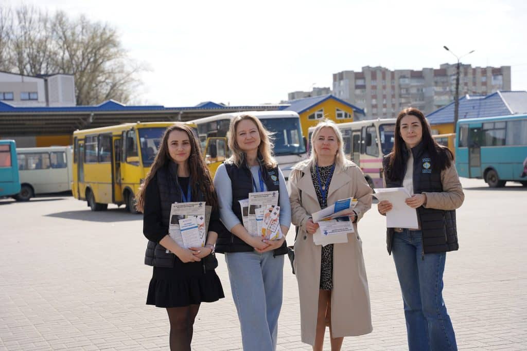 Caritas Drohobych team with prevention leaflets at the bus station
