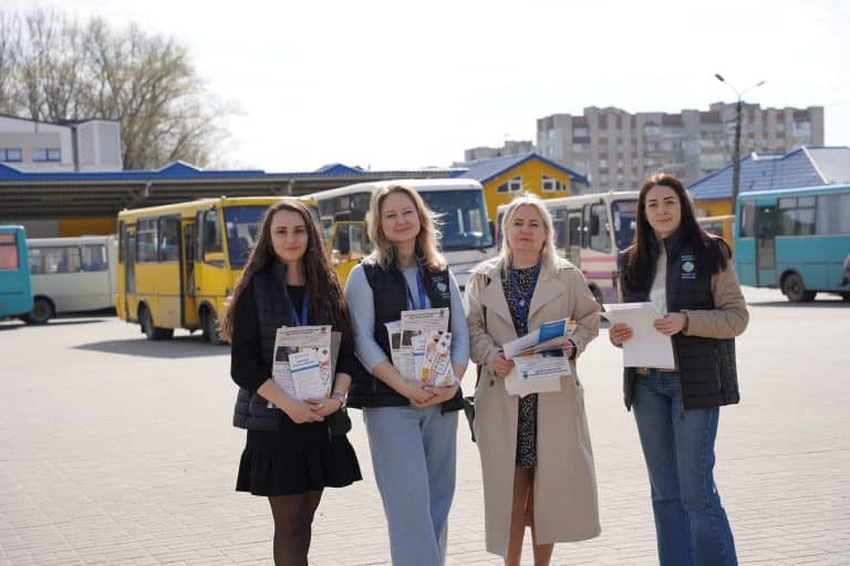 Caritas Drohobych team with prevention leaflets at the bus station
